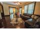 A living room features a black leather sofa, a fireplace, and an open doorway at 215 W Eastway Drive Dr, Charlotte, NC 28213