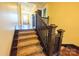 Elegant staircase with carpeted steps and dark wood trim leads to a hallway with natural light at 215 W Eastway Drive Dr, Charlotte, NC 28213