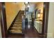 Carpeted stairs rise adjacent to a yellow hallway, displaying classic architectural charm at 215 W Eastway Drive Dr, Charlotte, NC 28213