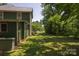 Spacious yard with lush grass and mature trees, showcasing the green home exterior at 215 W Eastway Drive Dr, Charlotte, NC 28213