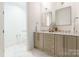 Bathroom featuring double sinks with modern fixtures and drawers for storage at 222 S Caldwell St # 2203, Charlotte, NC 28202