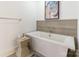 This modern tub includes upscale fixtures and tiled accent wall at 222 S Caldwell St # 2203, Charlotte, NC 28202