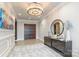 Inviting foyer with patterned floors, a modern chandelier, decorative touches, and paneled walls at 222 S Caldwell St # 2203, Charlotte, NC 28202