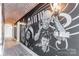 Hallway with hardwood floors, brick ceiling, and a custom mural with unique architectural details at 222 S Caldwell St # 2203, Charlotte, NC 28202