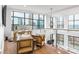 Bright home office with large windows, a modern desk setup, and comfortable seating area at 222 S Caldwell St # 2203, Charlotte, NC 28202