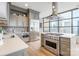 Modern kitchen featuring stainless steel appliances, gray cabinetry, and expansive city views at 222 S Caldwell St # 2203, Charlotte, NC 28202