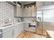 Well-appointed kitchen with custom backsplash, stainless steel appliances, and ample counter space at 222 S Caldwell St # 2203, Charlotte, NC 28202