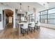 Bright kitchen with white countertops, an island with seating, and large windows with city views at 222 S Caldwell St # 2203, Charlotte, NC 28202