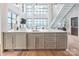 Open-concept living room featuring high ceilings, large windows, and sleek modern finishes at 222 S Caldwell St # 2203, Charlotte, NC 28202
