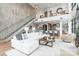 Expansive living area showcasing a staircase, modern decor, and panoramic views of the city at 222 S Caldwell St # 2203, Charlotte, NC 28202