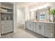 Elegant main bathroom offers dual sinks, ample storage, and adjacent toilet room at 222 S Caldwell St # 2203, Charlotte, NC 28202