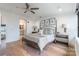 Bright main bedroom features a ceiling fan, wood floors, and ensuite bathroom access at 222 S Caldwell St # 2203, Charlotte, NC 28202