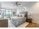This main bedroom features a large window with a city view and a tufted headboard at 222 S Caldwell St # 2203, Charlotte, NC 28202