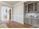 Chic wet bar with custom cabinetry, a wine rack, and elegant countertops next to the open floor at 222 S Caldwell St # 2203, Charlotte, NC 28202