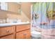 Bathroom with a white countertop and a beautiful beach themed shower curtain at 2279 Cedar Oak Cir, Gastonia, NC 28052