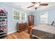 Bedroom with hardwood floors, two windows, and wooden furniture at 2279 Cedar Oak Cir, Gastonia, NC 28052