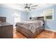 Comfortable bedroom with a large bed, a ceiling fan and beautiful wood floors at 2279 Cedar Oak Cir, Gastonia, NC 28052