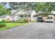 Driveway leading to a white single-story house with a front porch and metal carport at 2279 Cedar Oak Cir, Gastonia, NC 28052