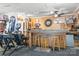Custom garage has a bar area with seating, wooden walls, and other unique décor at 2279 Cedar Oak Cir, Gastonia, NC 28052