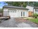 Exterior shot of garage with white siding, a gravel driveway and double doors at 2279 Cedar Oak Cir, Gastonia, NC 28052