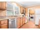 Kitchen featuring stainless steel dishwasher and sink, and access to the laundry at 2279 Cedar Oak Cir, Gastonia, NC 28052