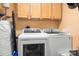 Convenient laundry room with modern washer and dryer units and ample cabinet storage at 2279 Cedar Oak Cir, Gastonia, NC 28052