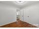 This bedroom features hardwood floors and white walls, leading to other rooms in the house at 2515 Danforth Ln, Charlotte, NC 28208