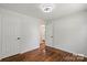 This bedroom features hardwood floors and white walls and trim, offering a neutral pallet at 2515 Danforth Ln, Charlotte, NC 28208