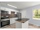 Modern kitchen featuring stainless steel appliances, a stylish backsplash, and a convenient center island at 2515 Danforth Ln, Charlotte, NC 28208