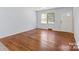 Bright living room featuring a large window and gleaming hardwood floors, creating a welcoming space at 2515 Danforth Ln, Charlotte, NC 28208