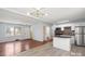 Open-concept living space featuring hardwood floors that blend seamlessly with a modern kitchen and bright lighting at 2515 Danforth Ln, Charlotte, NC 28208
