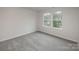 Bright bedroom with plush carpeting and windows providing natural light and neighborhood views at 2591 Watson Dr, Lancaster, SC 29720