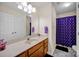 Practical bathroom featuring a single sink vanity with ample counter space and a shower with a blue curtain at 2620 Yarrow Rd, Charlotte, NC 28213