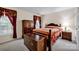 Cozy bedroom is well lit and features a bed with a wooden frame, chest, and matching nightstand at 2620 Yarrow Rd, Charlotte, NC 28213