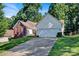 Inviting home with a brick facade, two-car garage, mature trees and a long driveway at 2620 Yarrow Rd, Charlotte, NC 28213
