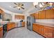 Bright kitchen with stainless steel appliances, oak cabinets, and neutral tile flooring at 2620 Yarrow Rd, Charlotte, NC 28213