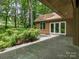 Backyard with green foliage, stone patio, and natural surroundings at 3310 Windbluff Dr, Charlotte, NC 28277