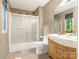 Bathroom featuring a glass-enclosed shower, modern vanity, and decorative mirror at 3310 Windbluff Dr, Charlotte, NC 28277
