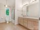 Bright bathroom featuring double vanity, lots of light, and a shower and bathtub at 3310 Windbluff Dr, Charlotte, NC 28277