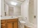Cozy bathroom with warm toned vanity, toilet, and bathtub with showerhead at 3310 Windbluff Dr, Charlotte, NC 28277