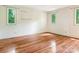 Bedroom with wood floors and three bright windows at 3310 Windbluff Dr, Charlotte, NC 28277