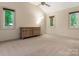 This spacious bedroom features neutral walls, large windows, and a ceiling fan at 3310 Windbluff Dr, Charlotte, NC 28277