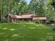 Beautiful two-story home boasts a lush green lawn with mature landscaping at 3310 Windbluff Dr, Charlotte, NC 28277
