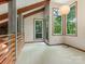 Open concept living space with unique exposed beams and floor to ceiling windows at 3310 Windbluff Dr, Charlotte, NC 28277