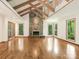 Spacious living room featuring hardwood floors, stone fireplace and multiple windows at 3310 Windbluff Dr, Charlotte, NC 28277