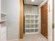 Small storage area with carpet, shelving unit, and a wooden door, perfect for organization at 3310 Windbluff Dr, Charlotte, NC 28277