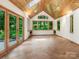 Bright sunroom featuring tile floors, wood ceiling and multiple windows at 3310 Windbluff Dr, Charlotte, NC 28277