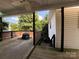 A partially covered deck includes a view of light beige siding and dark metalwork at 333 Mount View Ln # 266 B, New London, NC 28127
