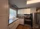 Updated kitchen featuring white cabinets, granite countertops, and stainless steel appliances at 333 Mount View Ln # 266 B, New London, NC 28127
