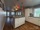 Spacious kitchen flowing into the living room, featuring a central island with white cabinets, countertops, and backsplash at 333 Mount View Ln # 266 B, New London, NC 28127